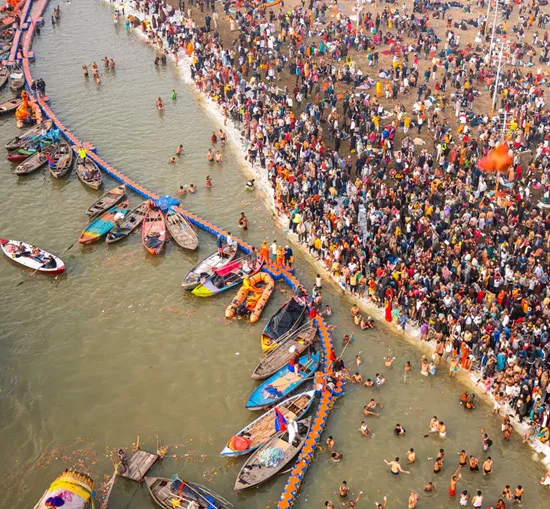 Aerial view of a crowded river ghat with boats