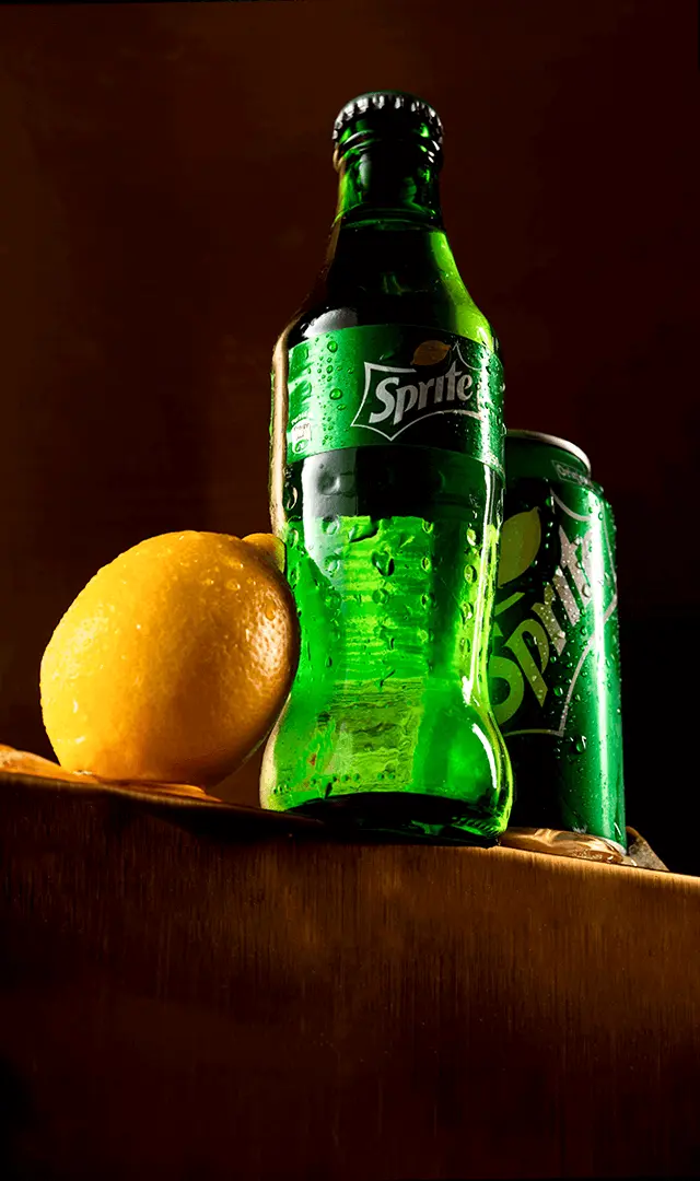 Sprite bottle and can with a fresh lemon
